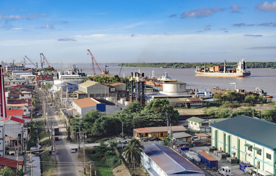Georgetown, Guyana with industrial activity along the waterfront of the Demerara River and a cargo ship in the background