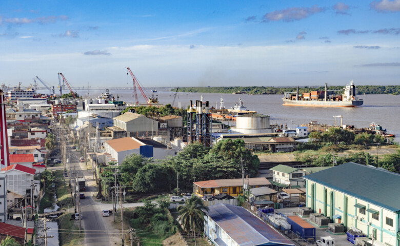 Georgetown, Guyana with industrial activity along the waterfront of the Demerara River and a cargo ship in the background