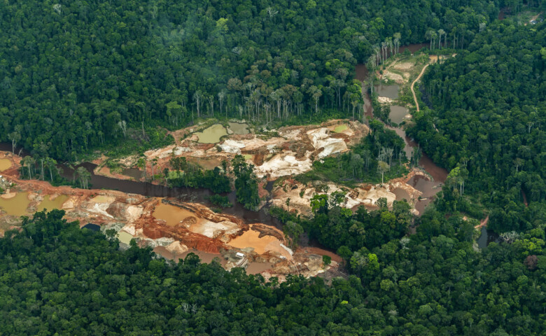 Aerial shot of illegal gold mining in the middle of the Amazon rainforest, Essequibo region, Guyana. Illegal and unregulated gold mining is responsible for the spread of malaria, human rights abuses and environmental damage including deforestation and the release of mercury into the ecosystem. The Essequibo territory is the subject of a dispute between Guyana and Venezuela.